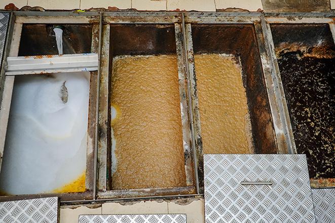 a grease trap cleaning service operating at a commercial kitchen